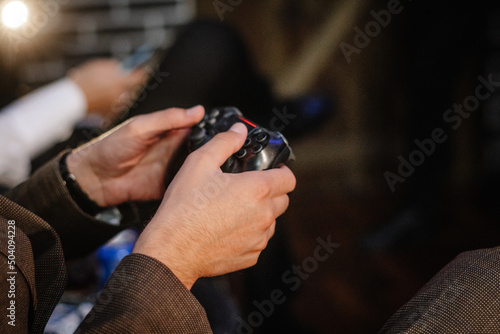 hands of a gamer playing on a gamepad