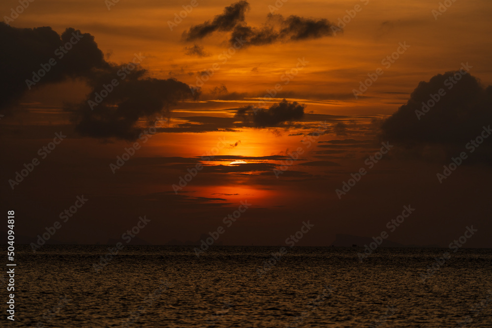 Beautiful sunset over the sea water on the island of Koh Phangan, Thailand. Travel and nature concept