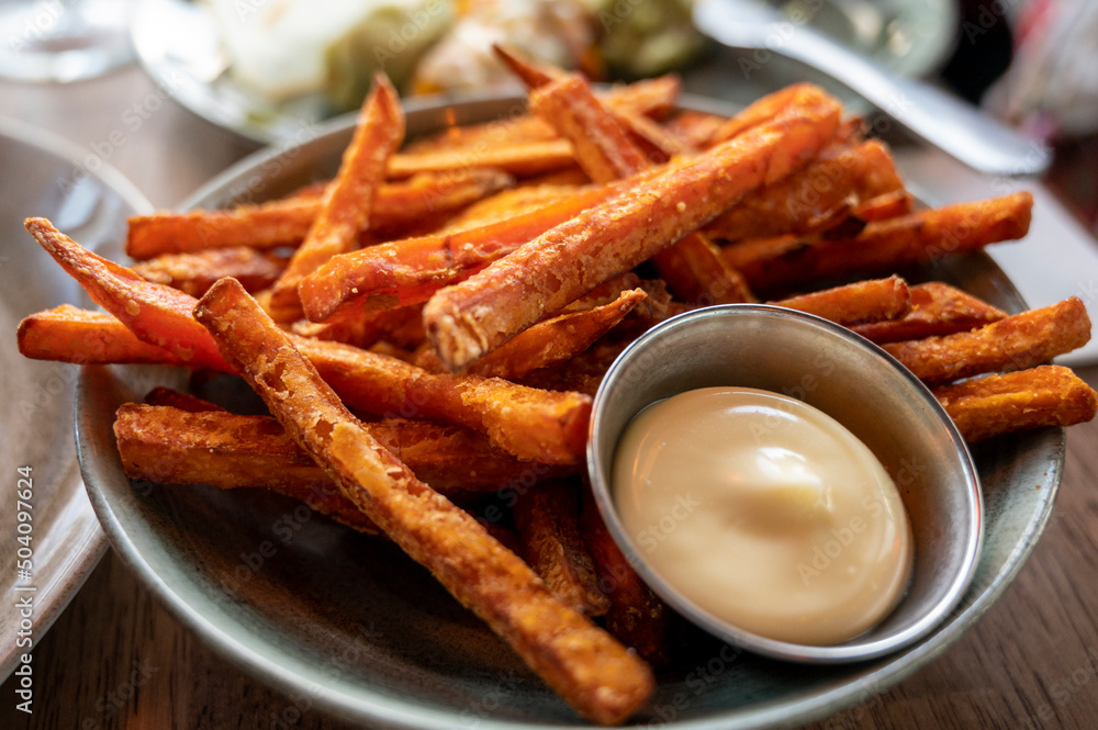 Bowl with deep fried sweet potato chips served with mayonnaise sauce Bowl with deep fried sweet potato chips served with mayonnaise sauce