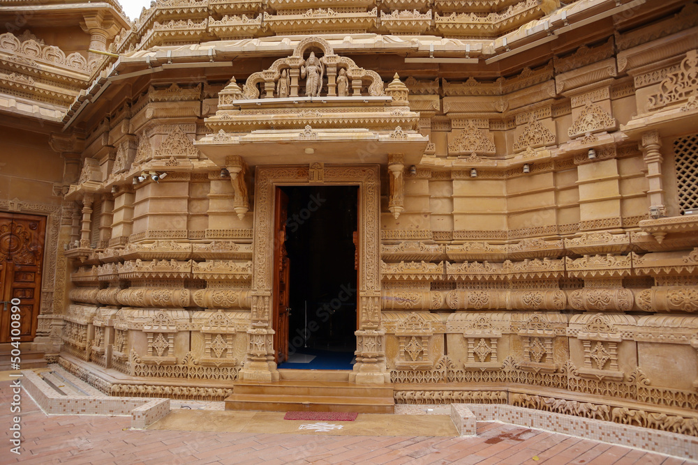 A Close up view of the exterior architecture of the Hanuman temple built in sand stone with detailed carvings at Mysuru in Karnataka, India.