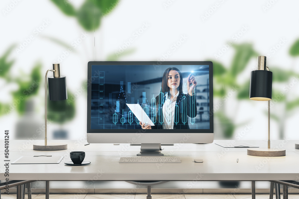 businesswoman giving financial education on screen with business chart, placed on desktop on blurry bright office workplace interior background. businesswoman giving financial education on screen with business chart, placed on desktop on blurry bright office workplace interior background.