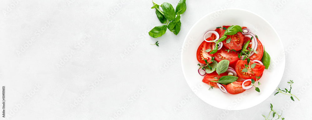 Salad with red ripe tomatoes, basil and olive oil. Top view. Banner Salad with red ripe tomatoes, basil and olive oil. Top view. Banner
