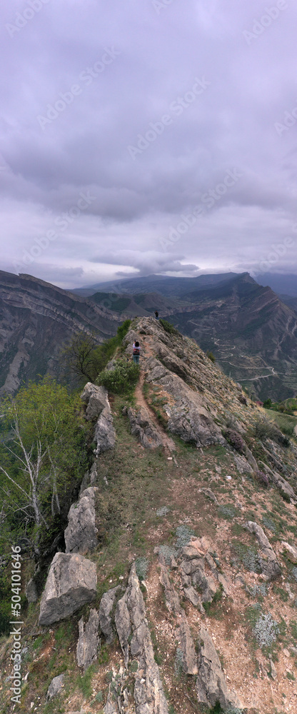 Fototapeta premium panoramic view of the Caucasus mountains gorges ancient fortresses and curved mountain roads on a spring day
