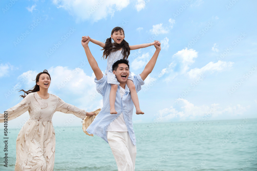 Family of three playing on the beach Family of three playing on the beach
