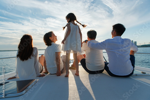 Happy family aboard a yacht out to sea