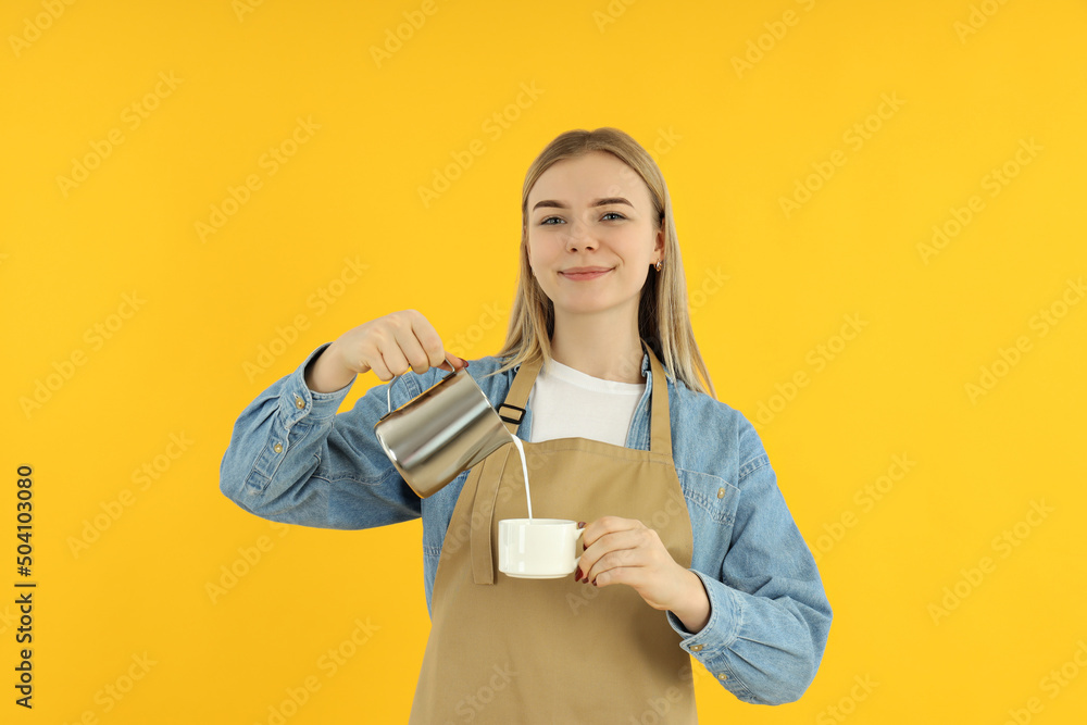 Obraz premium Concept of occupation, young barista on yellow background
