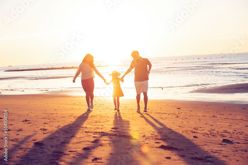 the family of three spend holiday at the seaside