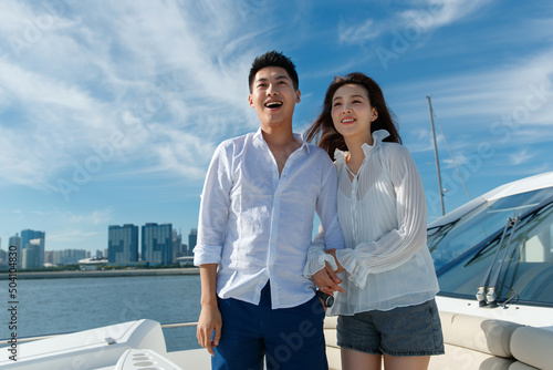 Romantic young couples aboard a yacht out to sea photo