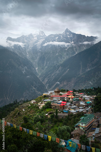 Elevated view of village dominated by Himalayas under cloudy sky. Kalpa, India.