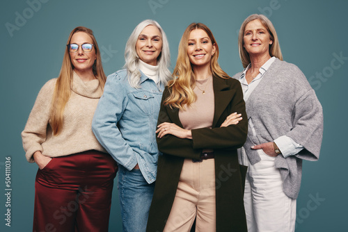 Smiling mature women standing together in a studio photo