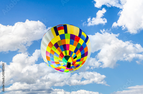 Colorful hot air balloon flying over blue sky