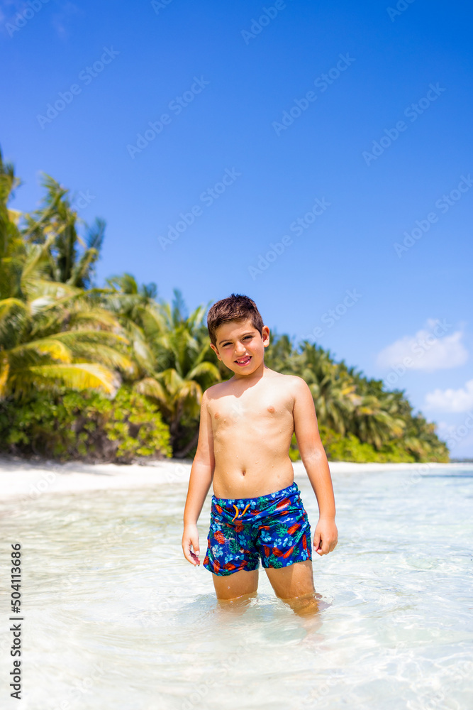 Little kid inside the water on a tropical beach Little kid inside the water on a tropical beach
