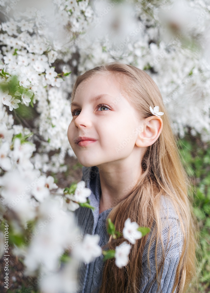 Cute little girl in a blossoming spring garden Cute little girl in a blossoming spring garden