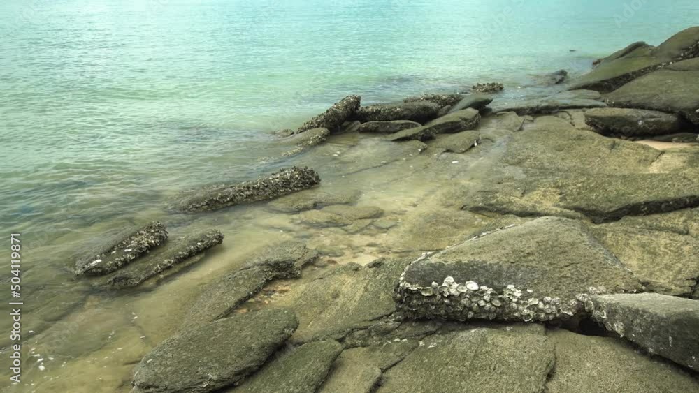Water sea rippling to surface reef rock on seashore Water sea rippling to surface reef rock on seashore