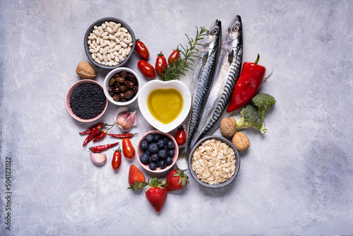 on the textured background, variety of Mediterranean healthy foods based on legumes, fish, vegetables, fruits and grains