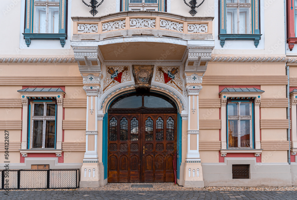 Fototapeta premium Beautiful antique arch wooden door entrance in the city square