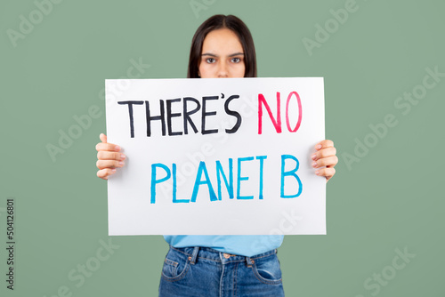 Serious teen girl enviromental activist holding a banner with there is no planet B text