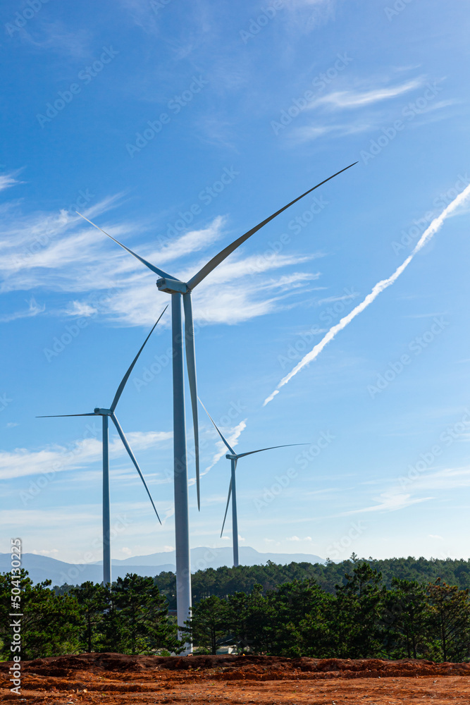 Renewable energy wind turbines windmill isolated on the beautiful blue sky and on the tea fields in Da Lat city, Lam Dong, Viet Nam Renewable energy wind turbines windmill isolated on the beautiful blue sky and on the tea fields in Da Lat city, Lam Dong, Viet Nam