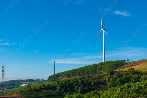 Renewable energy wind turbines windmill isolated on the beautiful blue sky and on the tea fields in Da Lat city, Lam Dong, Viet Nam