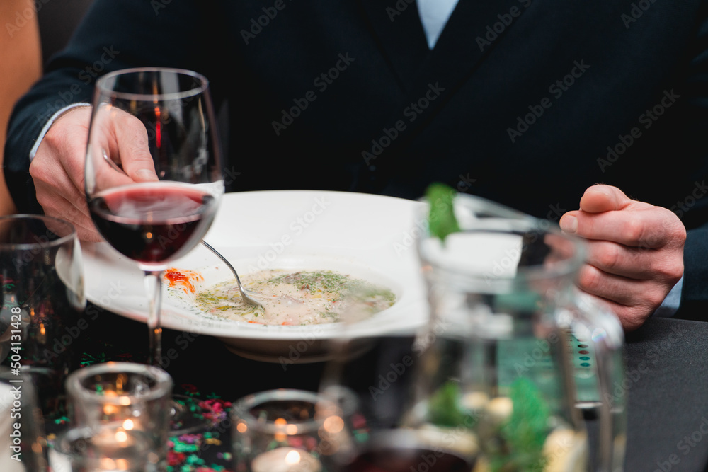 Man eating mushroom cream soup in a restaurant Man eating mushroom cream soup in a restaurant
