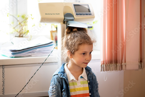 A little girl of 5 years old came to see a doctor. She measures her height and weight. Poan examination of children in the clinic. Taking care of children's health. Health. Medecine. Childhood.