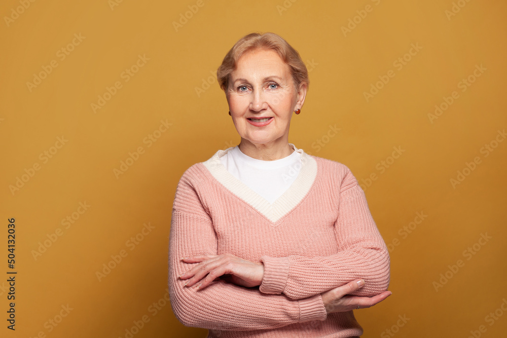 Smiling senior woman in pink sweater portrait Smiling senior woman in pink sweater portrait