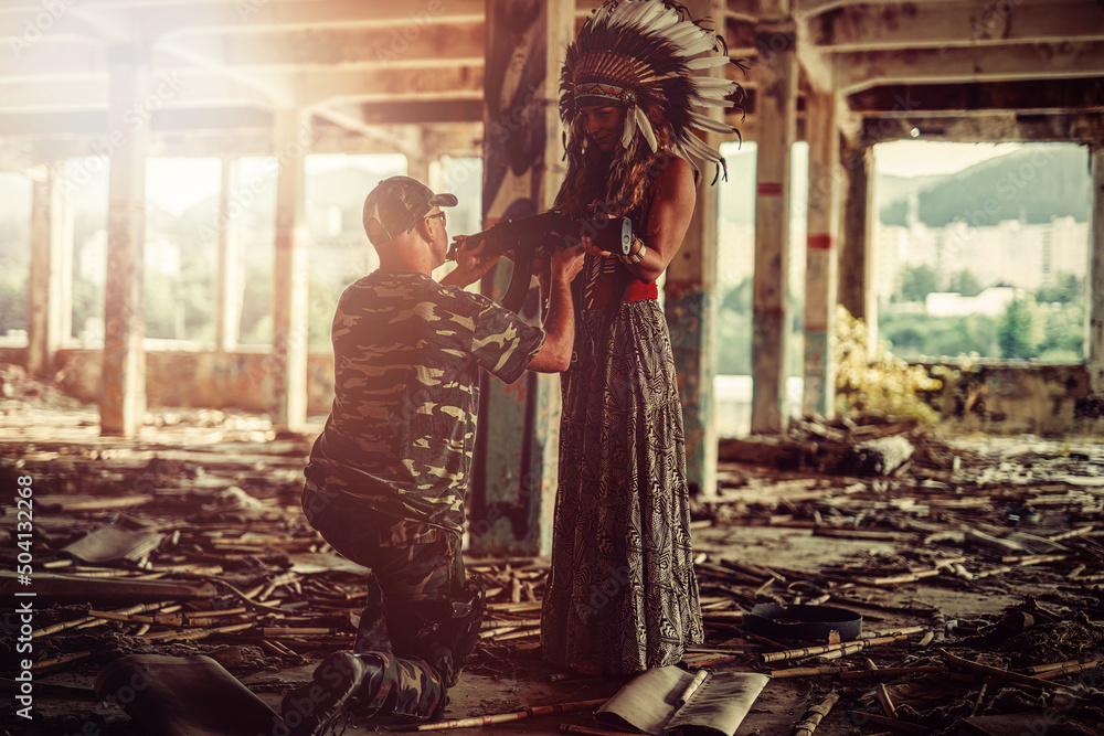 Airsoft soldier and indian woman in the old industry building. Airsoft soldier and indian woman in the old industry building.