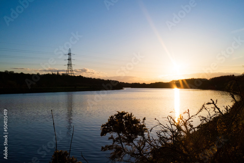 Pylon power lines against sunsetting sky crossing the River Tyne at Newburn  Newcastle upon Tyne 