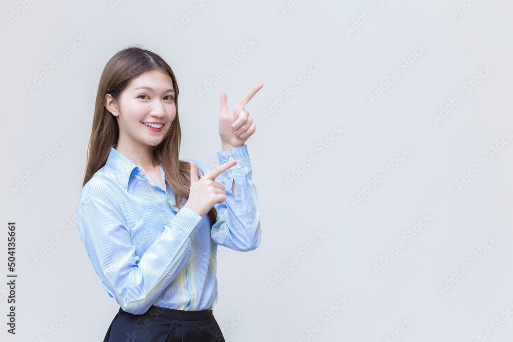 Asian professional business woman who has long hair with a blue shirt smiles present something on a white background. Asian professional business woman who has long hair with a blue shirt smiles present something on a white background.