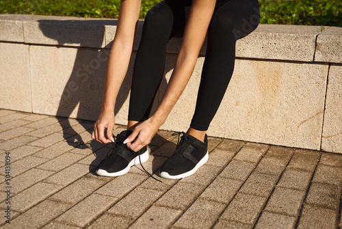 Woman preparing for jogging in park