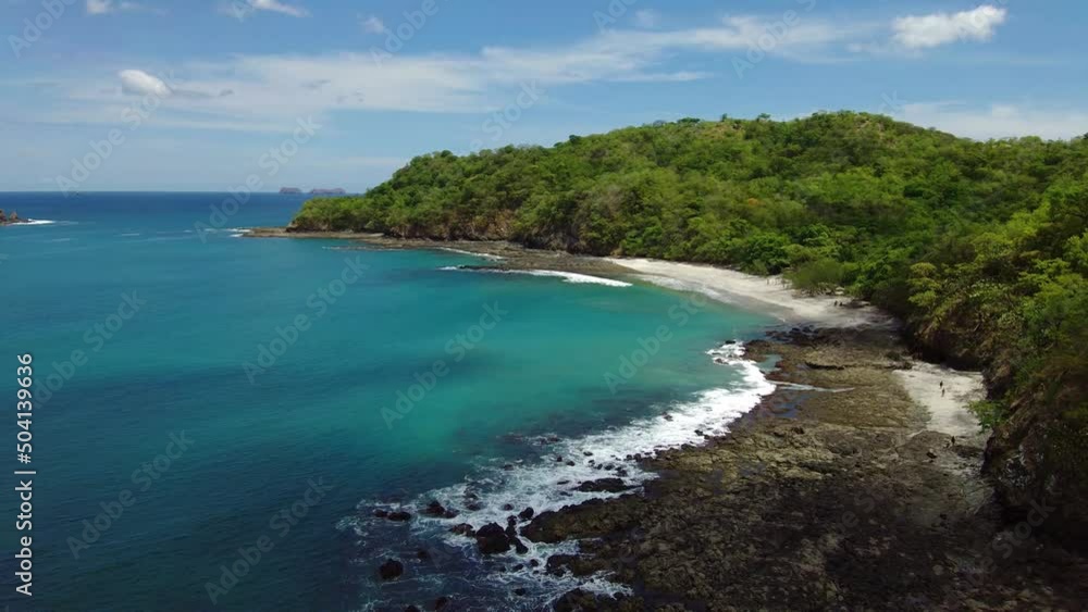 Tropical hidden white sand and blue turquoise water beach in Costa Rica. Aerial view in 4K Tropical hidden white sand and blue turquoise water beach in Costa Rica. Aerial view in 4K