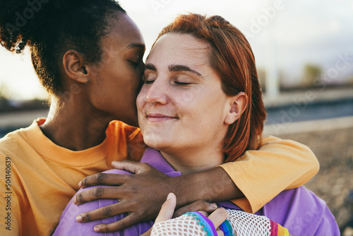 Happy women gay couple having tender moment outdoor - Lgbt and love concept photo