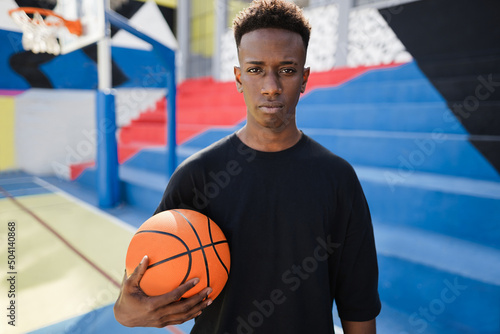 Young african man playing basketball outdoor - Focus on face
