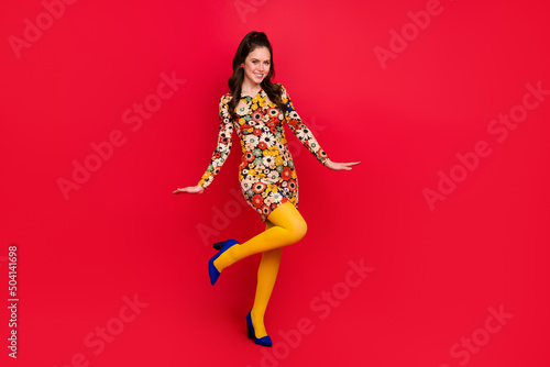 Full length body size view of attractive cheerful girl dancing posing good mood isolated over bright red color background