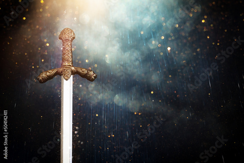 Tablou canvas photo of knight sword over dark background
