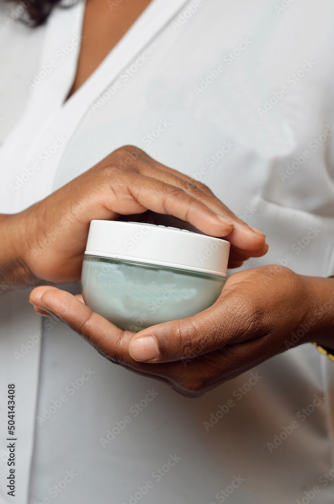 portrait of female hands holding a small bottle of product portrait of female hands holding a small bottle of product