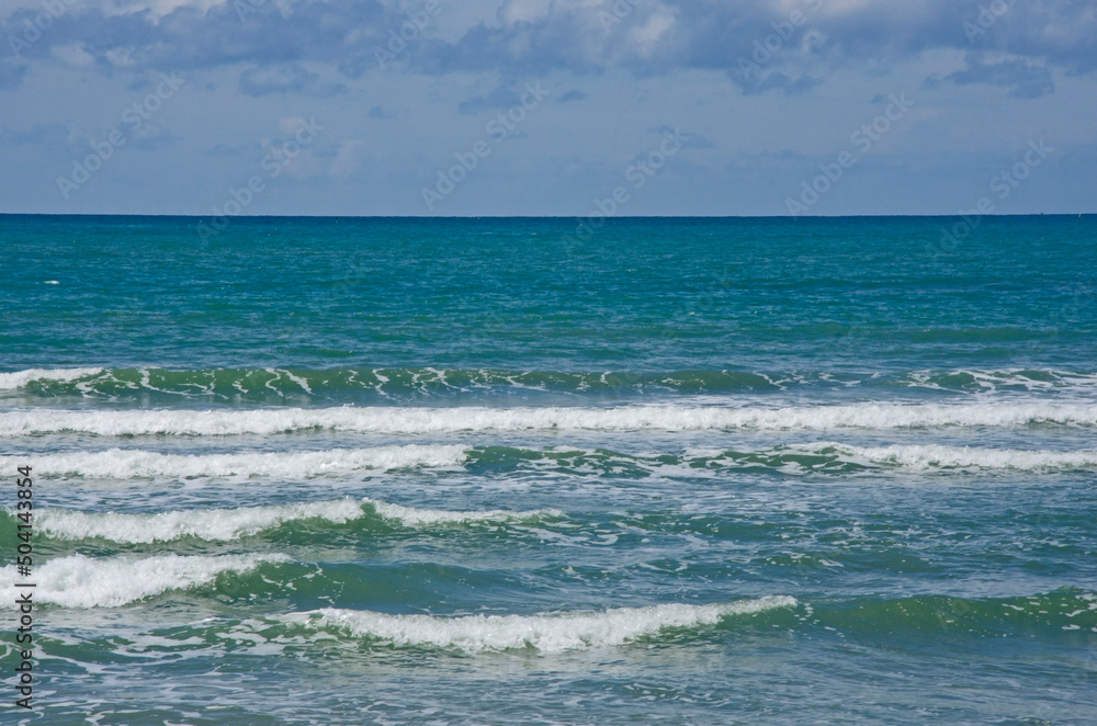 Beautiful white waves in the sea with blue sky background Beautiful white waves in the sea with blue sky background