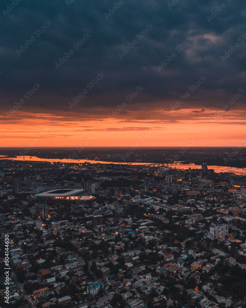 Dnipro, Ukraine. View of the central part of the city of the Dnieper. Top view from a great height. Panoramic view of the city. Dawn or sunset over the city. orange sky