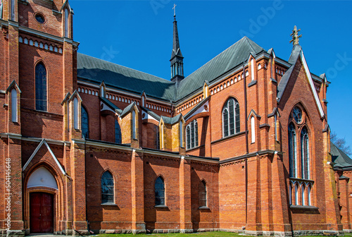 The photos show a general view of the Catholic Church of the Nativity of the Blessed Virgin Mary in the village of Rajgród in Podlasie, Poland, built in the neo-Gothic style in 1905-1912. photo