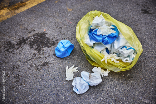 Yellow trash bag of biohazard medical waste on the street, environmental pollution due to the flu pandemic.