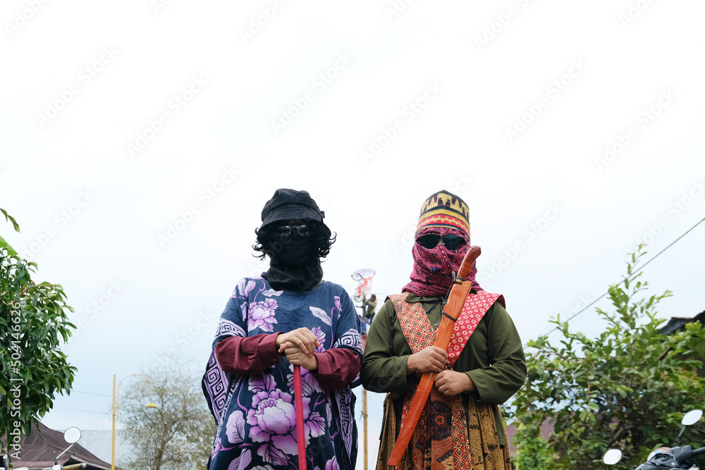 Traditional costumes and masks parade in Lampung, Indonesia. SEKURA or masquerade festival