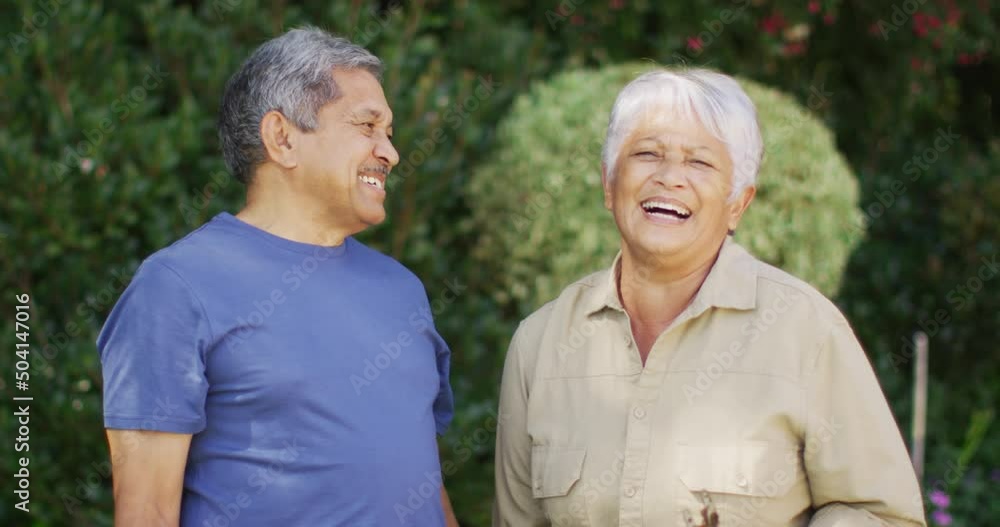 Video of happy biracial senior couple laughing and talking in garden Video of happy biracial senior couple laughing and talking in garden