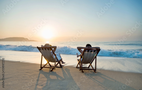 Obraz na płótnie Couple sunbathing on a beach chair.