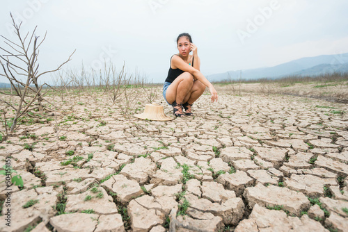woman portrait in dryland with drought ground texture. concept climate changed.