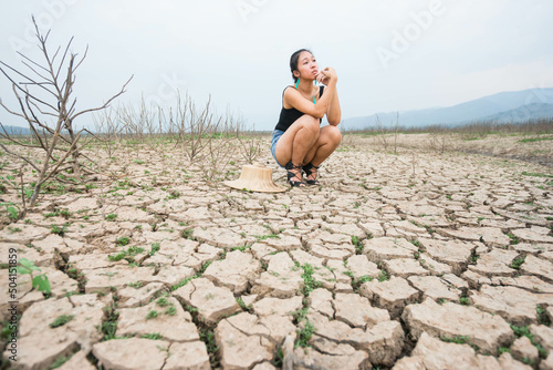 woman portrait in dryland with drought ground texture. concept climate changed.