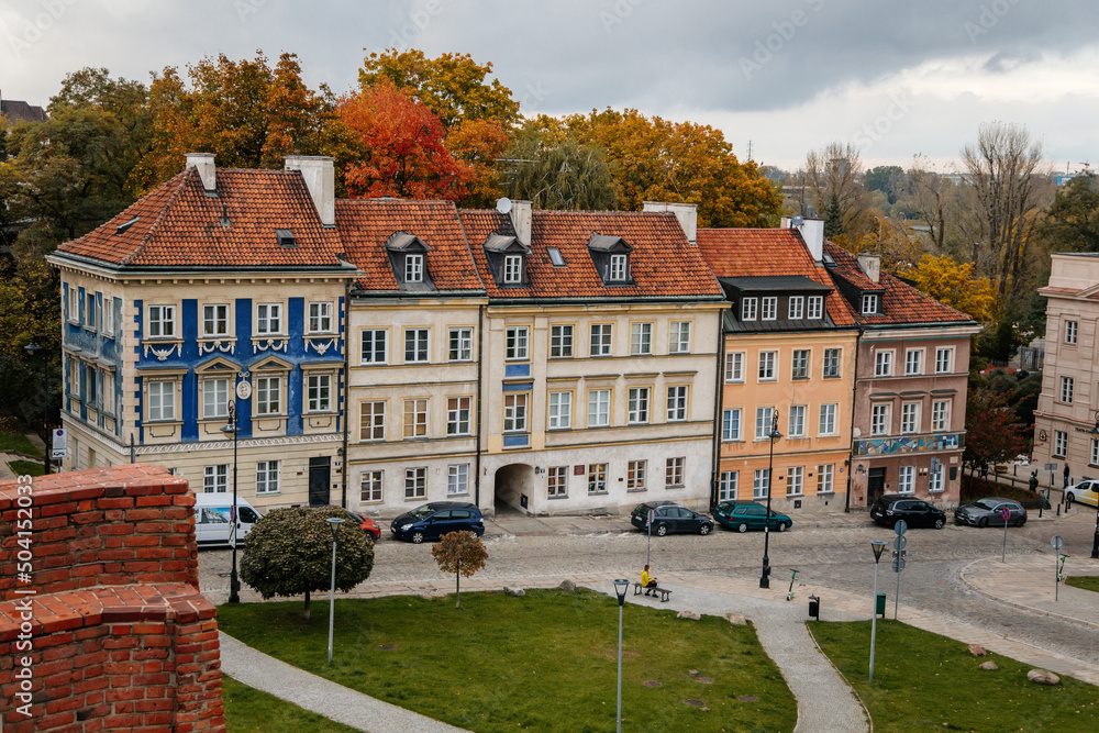 Warsaw, Poland, 13 October 2021: picturesque street with colorful buildings in historic center in medieval city, renaissance and baroque historical buildings near Barbican fortifications, sunny day