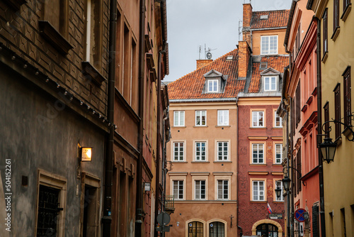 Warsaw  Poland  13 October 2021  Narrow picturesque street with colorful buildings in historic center in medieval city  renaissance and baroque historical buildings at old town  sunny autumn day