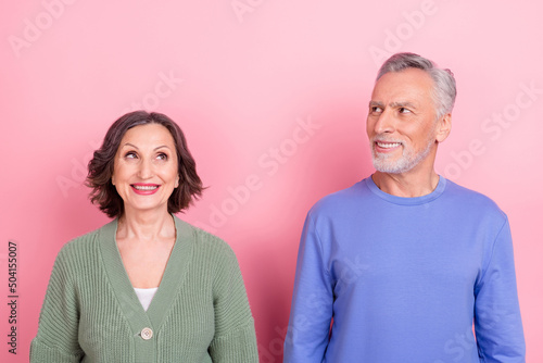 Portrait of two positive minded people look interested empty space dream isolated on pink color background
