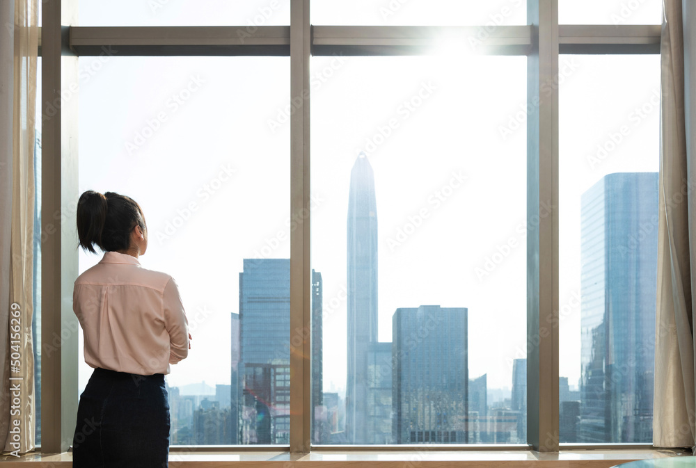 Businesswoman standing in front of the window Businesswoman standing in front of the window