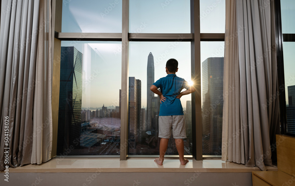 Little boy standing in front of window Little boy standing in front of window